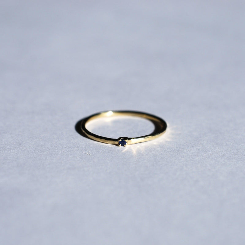 Thin hammered ring with sapphire